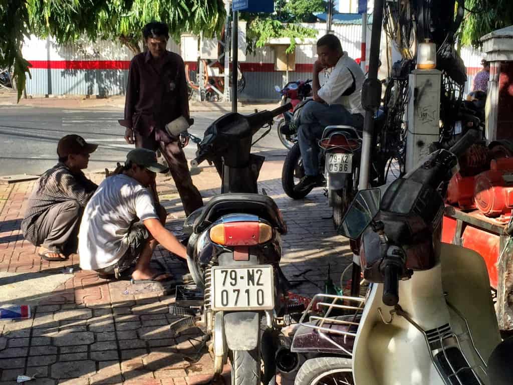 A mechanic sets up shop on the sidewalk in Nha Trang