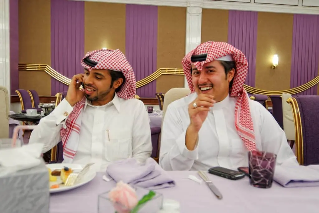 two saudi men at table