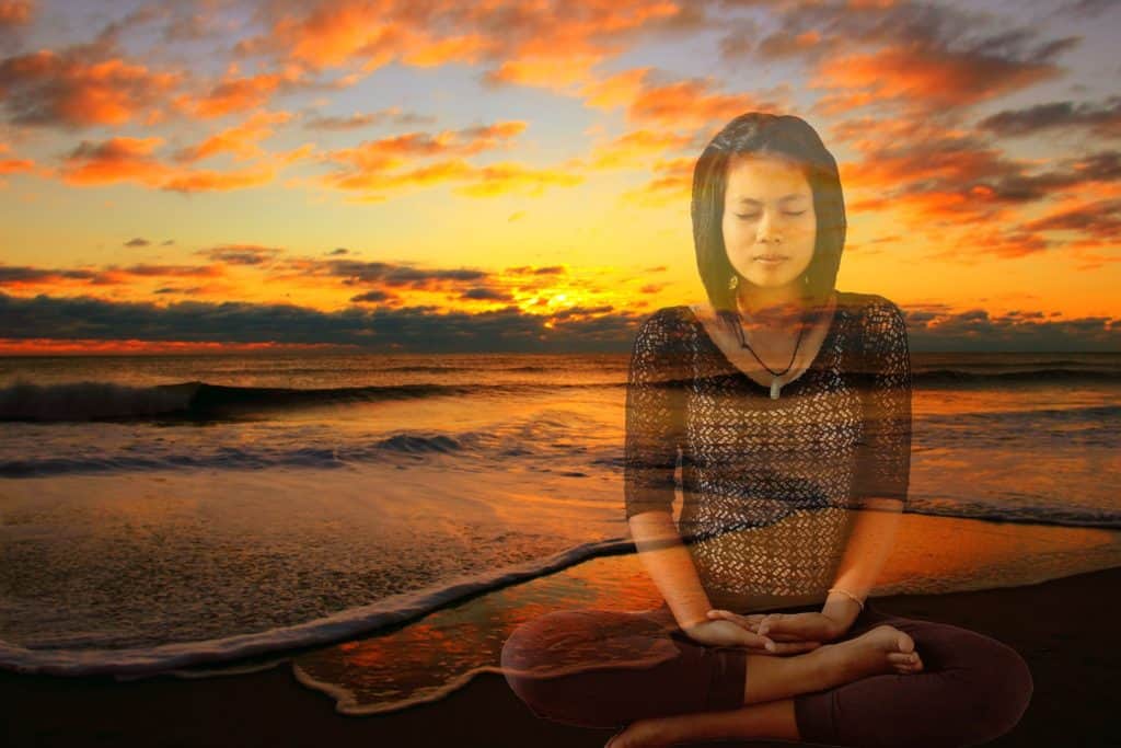 girl meditating sunset