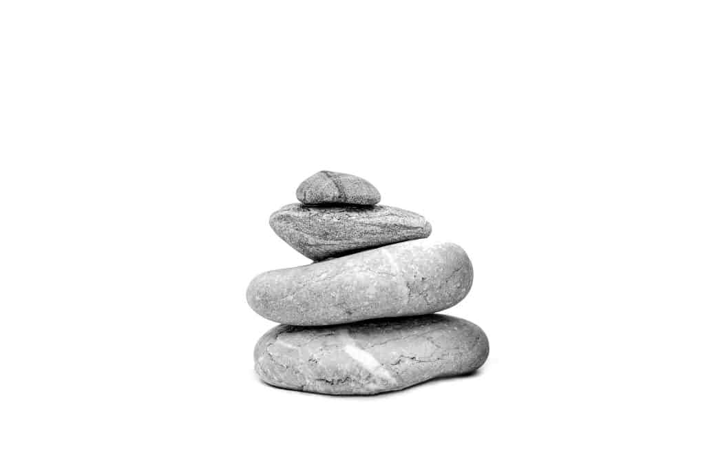 zen stacked stones on white background
