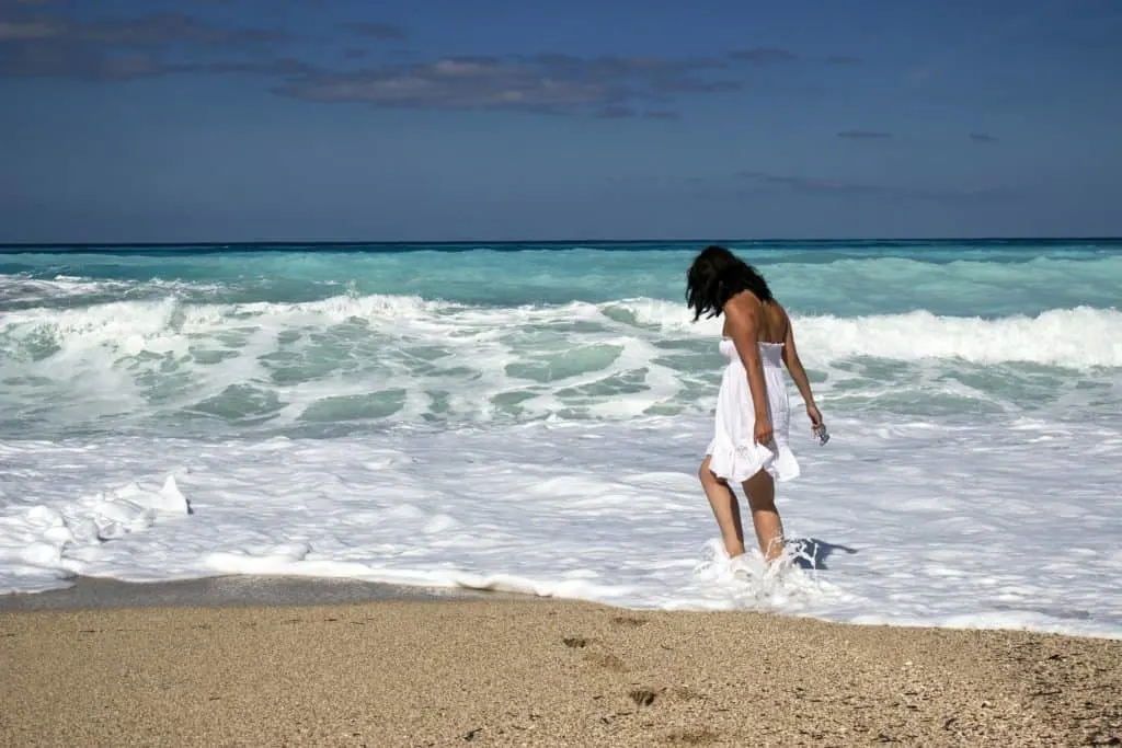 woman walking on the sandy shore