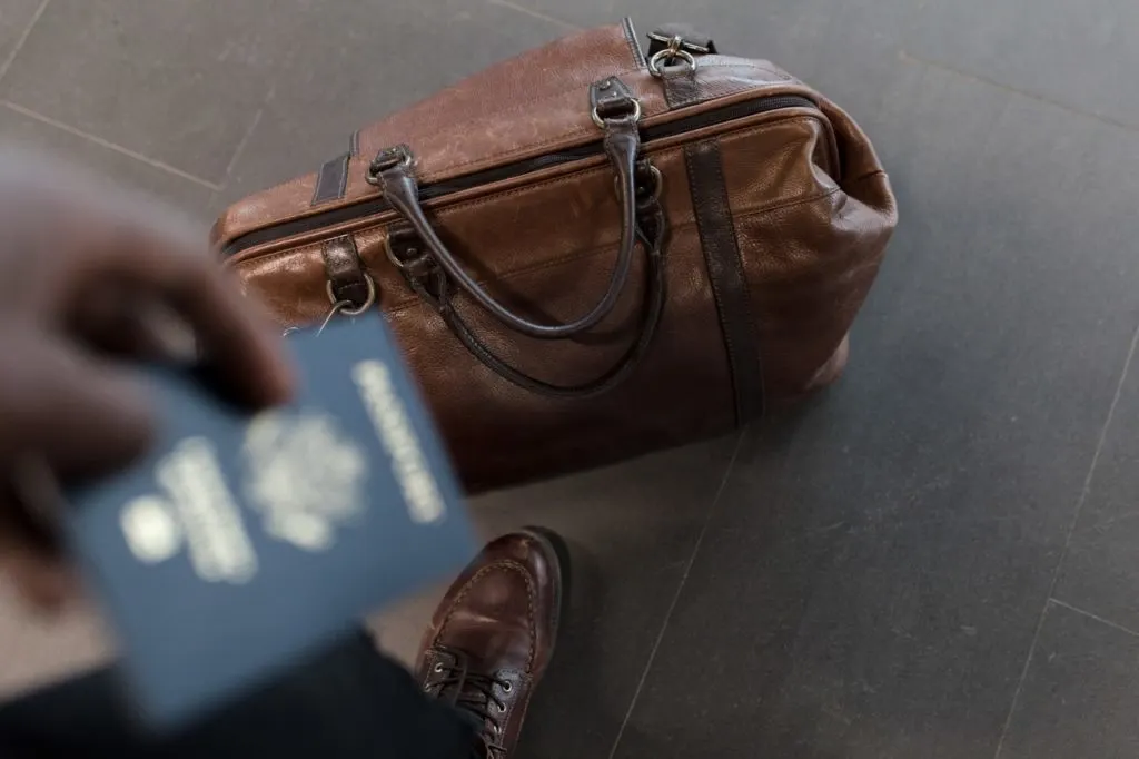 leather duffel bag and passport