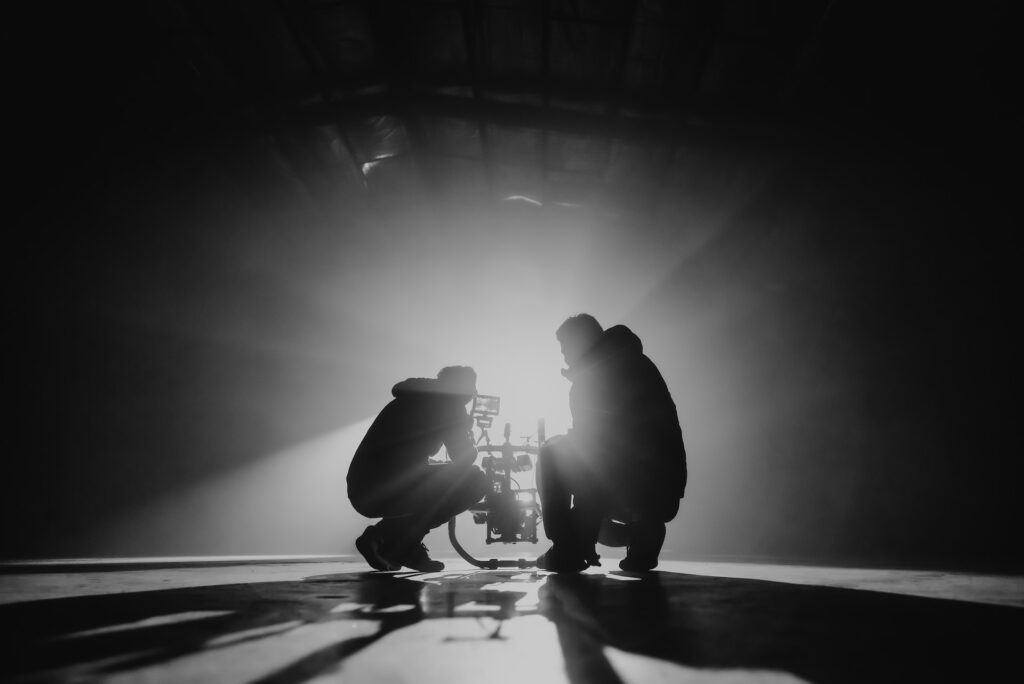 silhouette of director and producer lining up a cshot