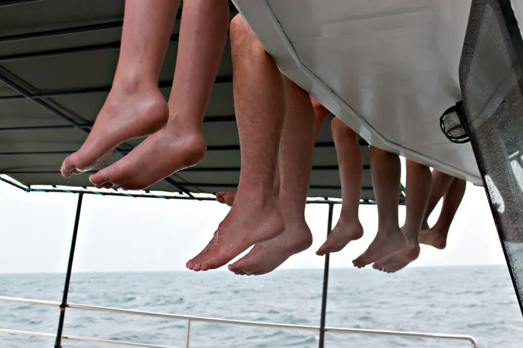 feet hanging off catamaran maui whale watching