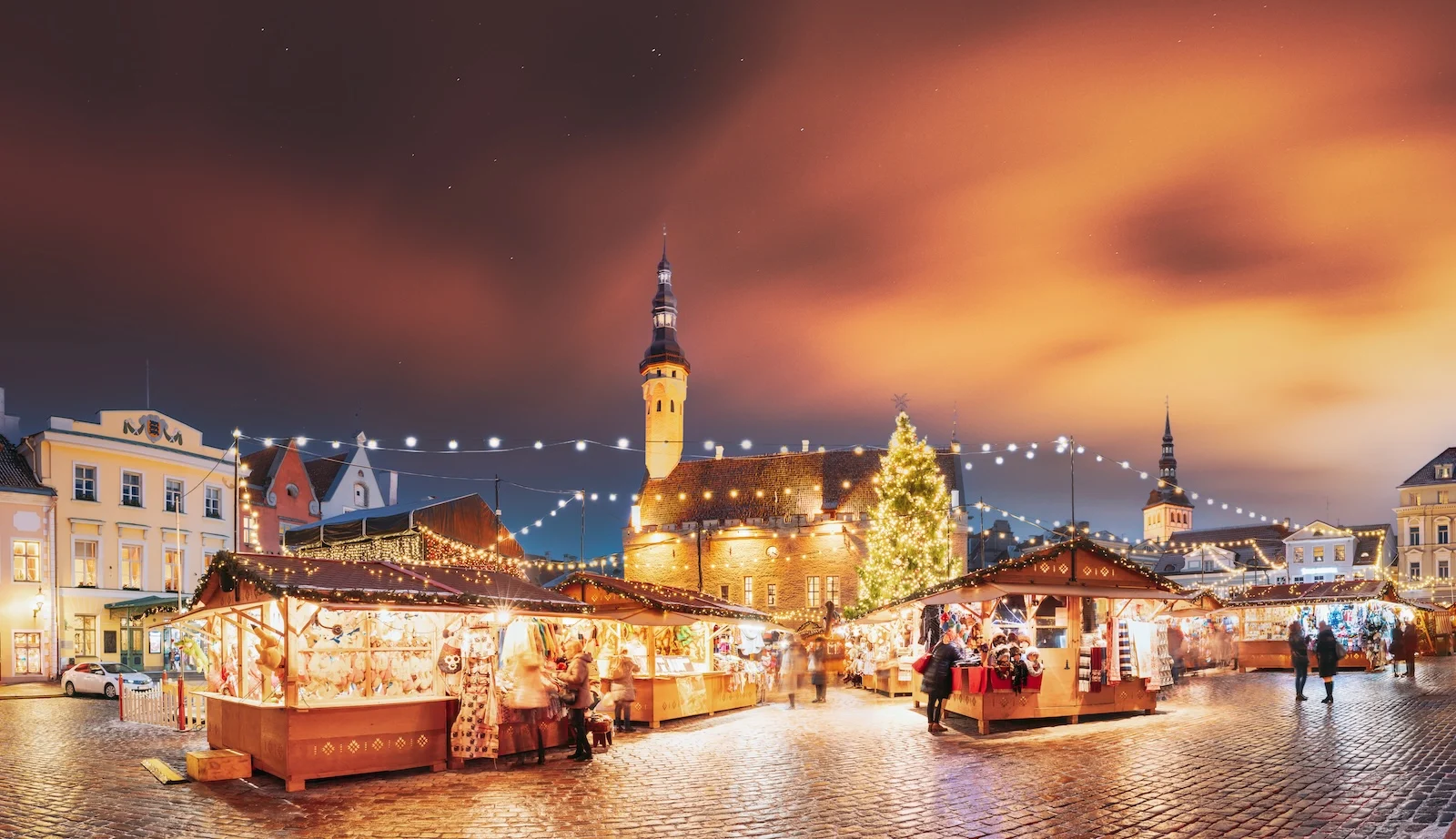 Tallinn, Estonia. Traditional Christmas Market On Town Hall Square. Trading Houses With Sale Of Christmas Gifts. Night Sky Above Famous Landmark. Altered Night Sky. Panorama, Panoramic View.