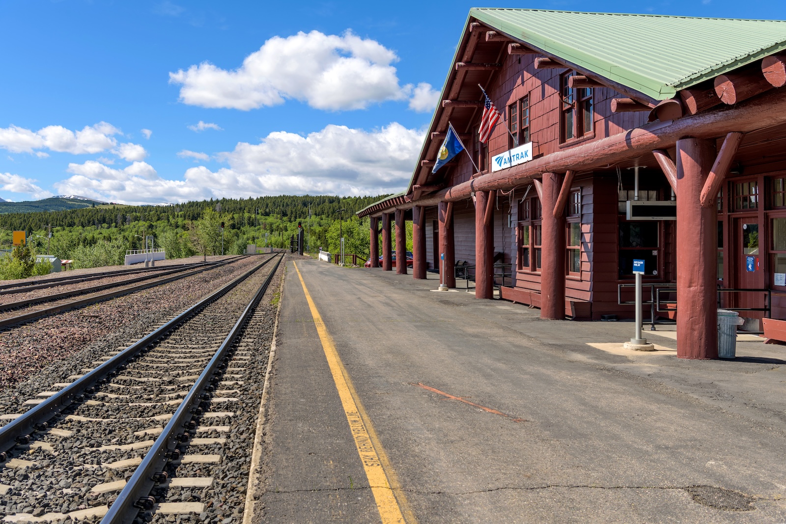 East Glacier Park, Montana, USA - June 7, 2021: A Spring morning view of the platform of the Amtrak Train Station, located just outside of Glacier National Park.