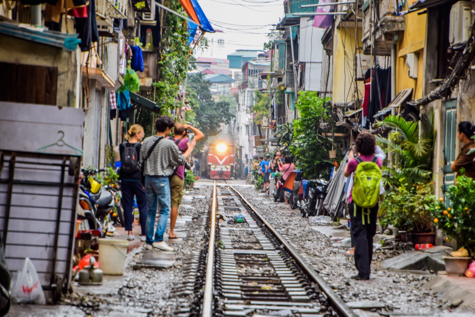 Popular place and One of the main attraction of Hanoi at Vietnam, Train passing through a narrow street in the Hanoi Old Houses, Transportation of Hanoi, Black soot from the chimney, Blur image.