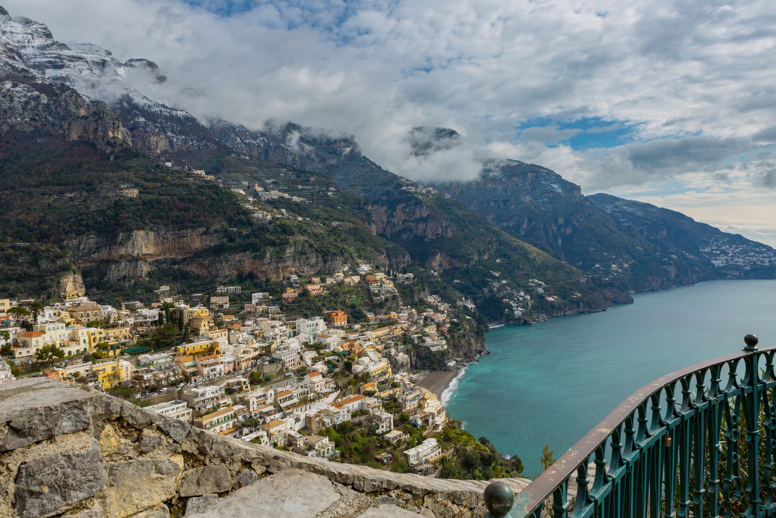 Positano on the Amalfi coast, Italy in wintertime with a mountain range in the background covered with snow