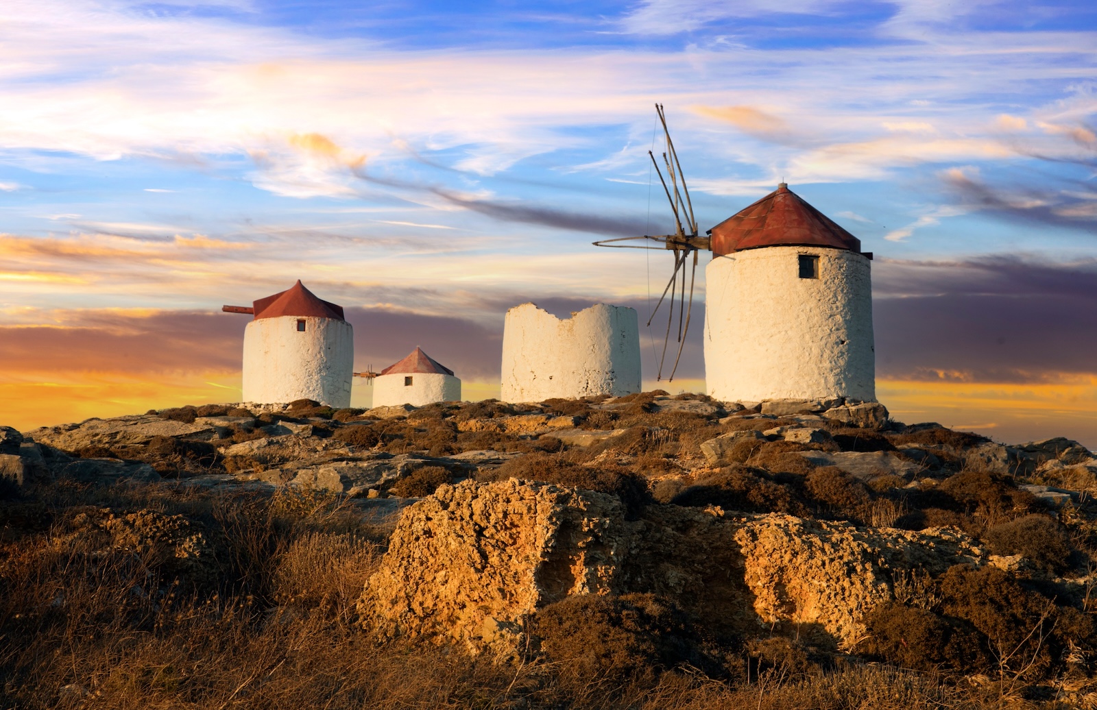 Traditional typical greek windmills. Amorgos island in Cyclades, Chora village over sunset