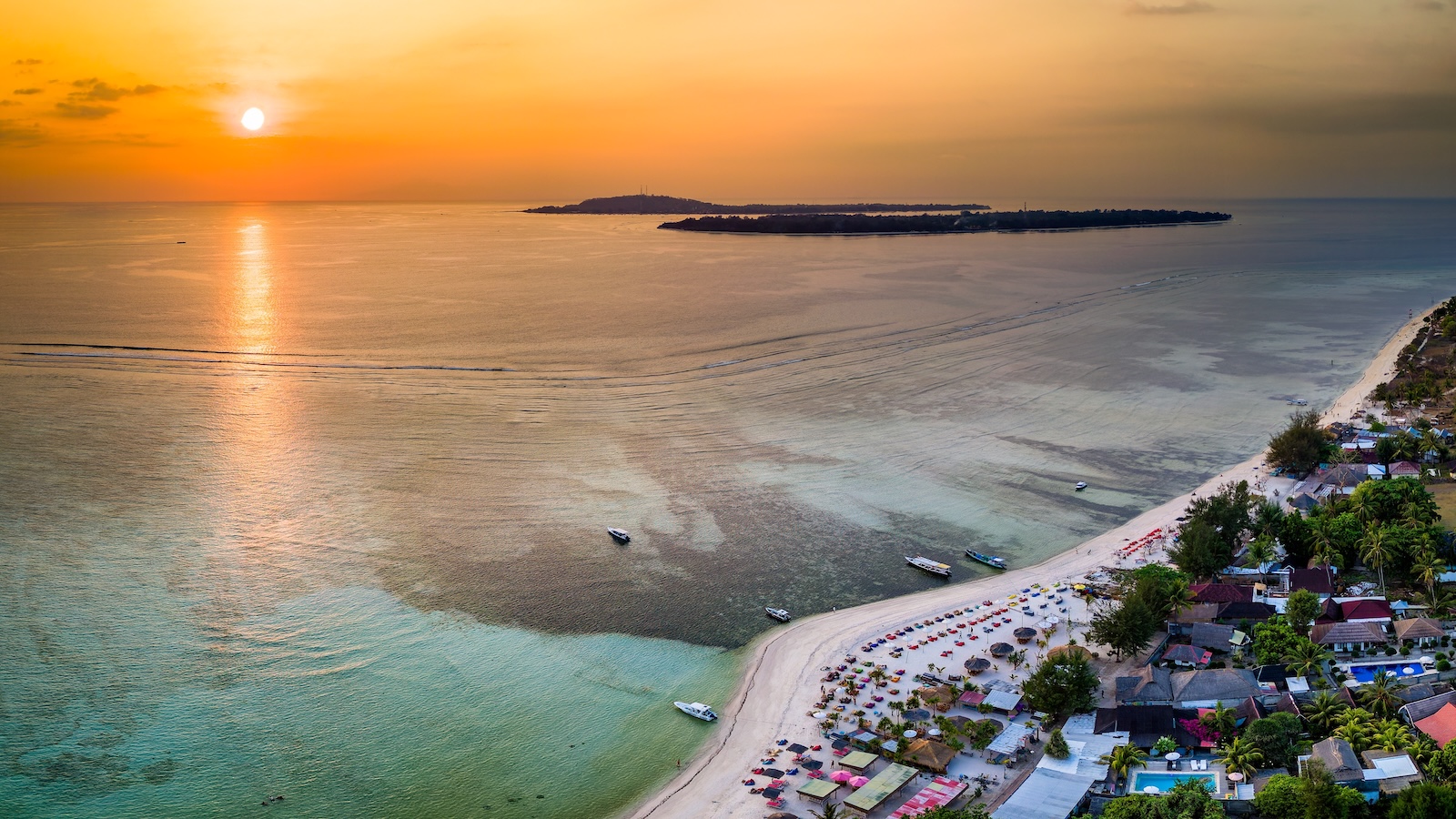 Aerial view of a beautiful tropical sunset and sandy beach (Gili Islands, Indonesia)