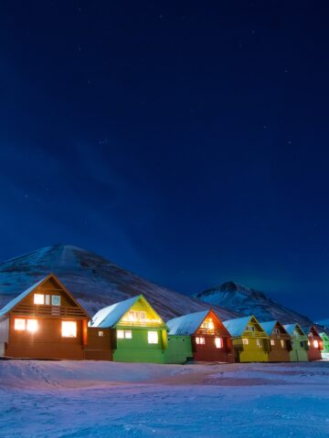 The polar arctic Northern lights aurora borealis sky star in Norway Svalbard in Longyearbyen the moon mountains