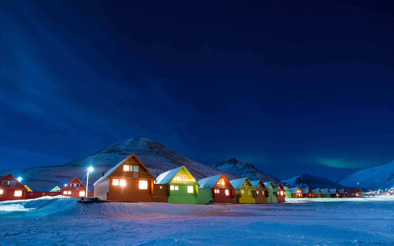 The polar arctic Northern lights aurora borealis sky star in Norway Svalbard in Longyearbyen the moon mountains