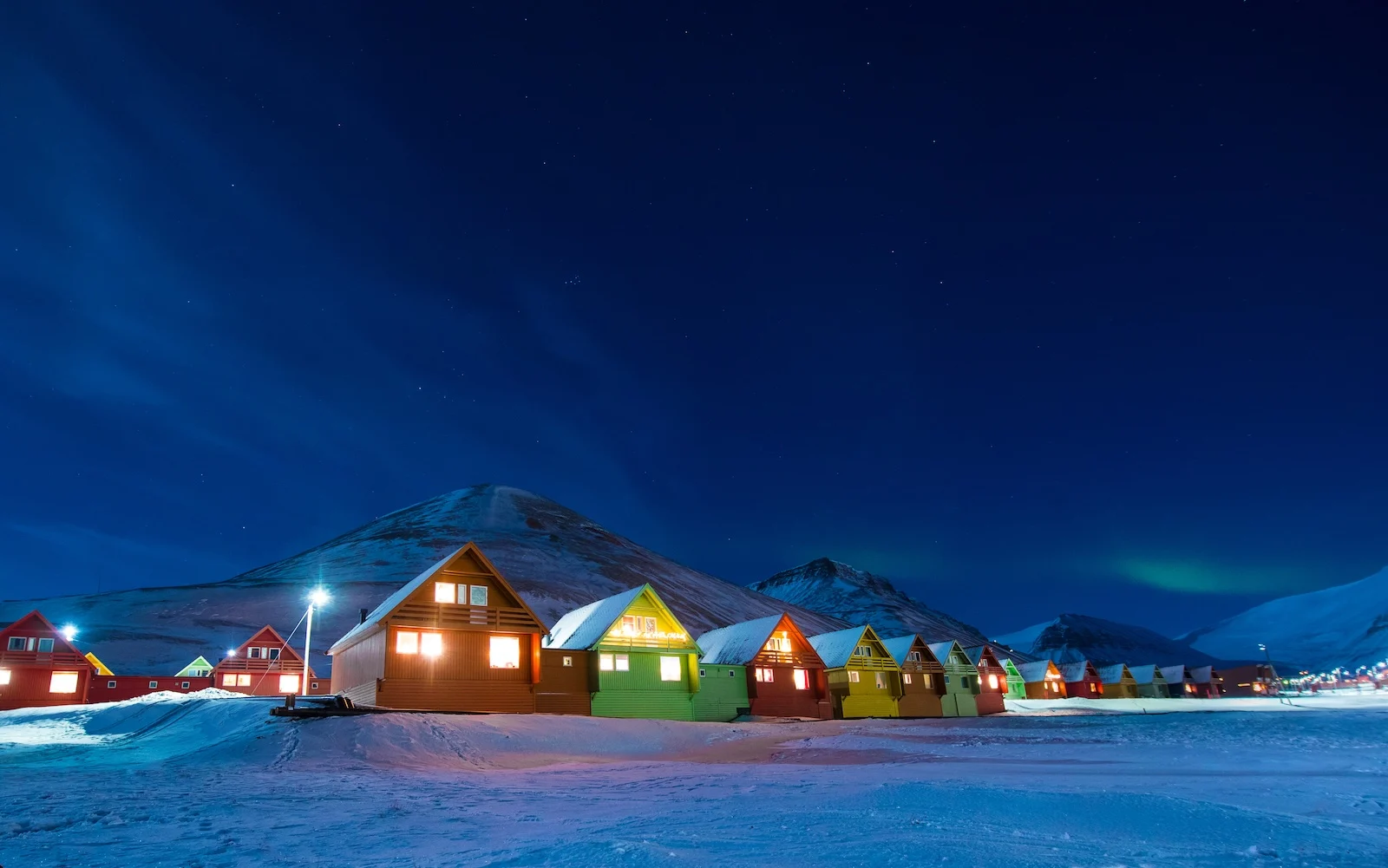 The polar arctic Northern lights aurora borealis sky star in Norway Svalbard in Longyearbyen the moon mountains