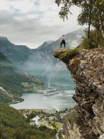 Geiranger, Norway. Woman Standing on the Cliff