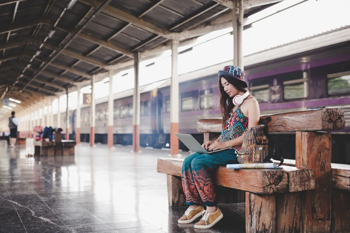 woman holding map train station tourism concept